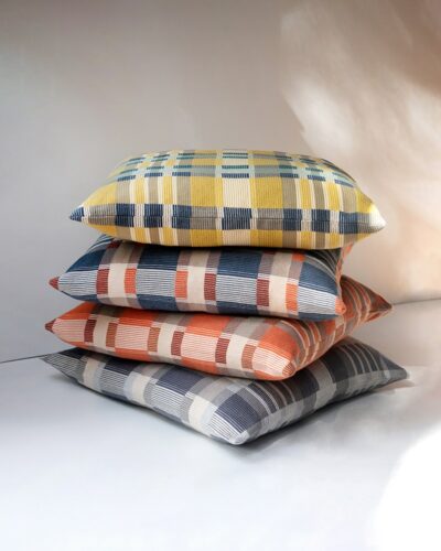 A stack of four colourful cotton Mungo cushions