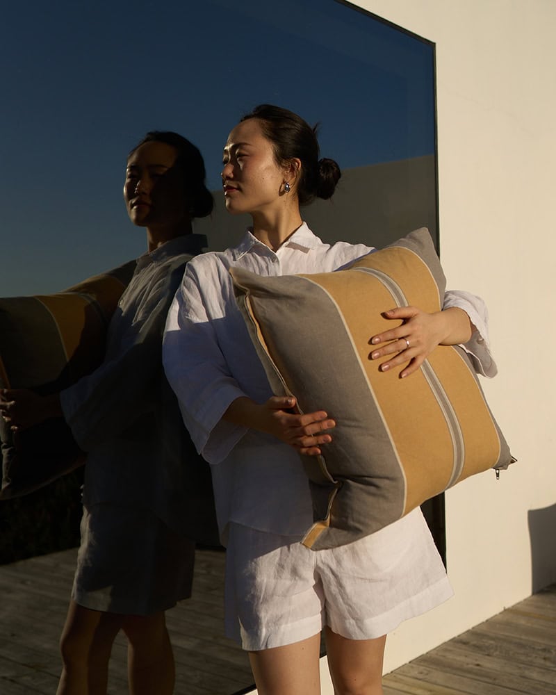 Model holding a Lisburn Cushion Cover