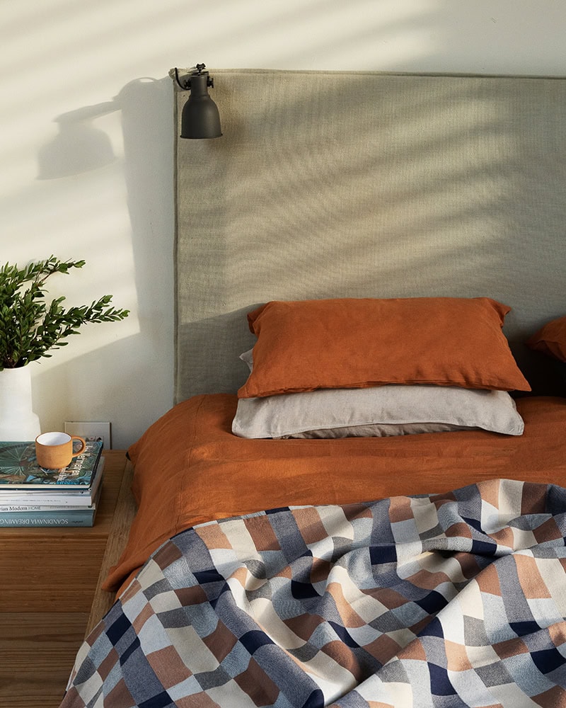 The versatile Mungo Double Cloth throw on the Terracotta linen duvet cover. Woven at the Mungo Mill with 100% cotton.